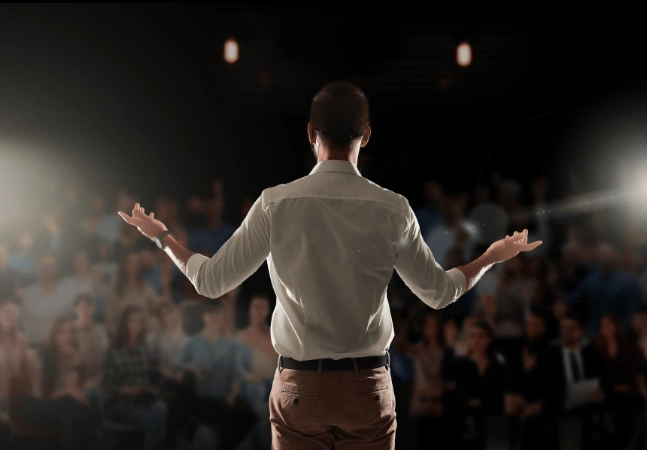 Person speaking to an audience at a conference
